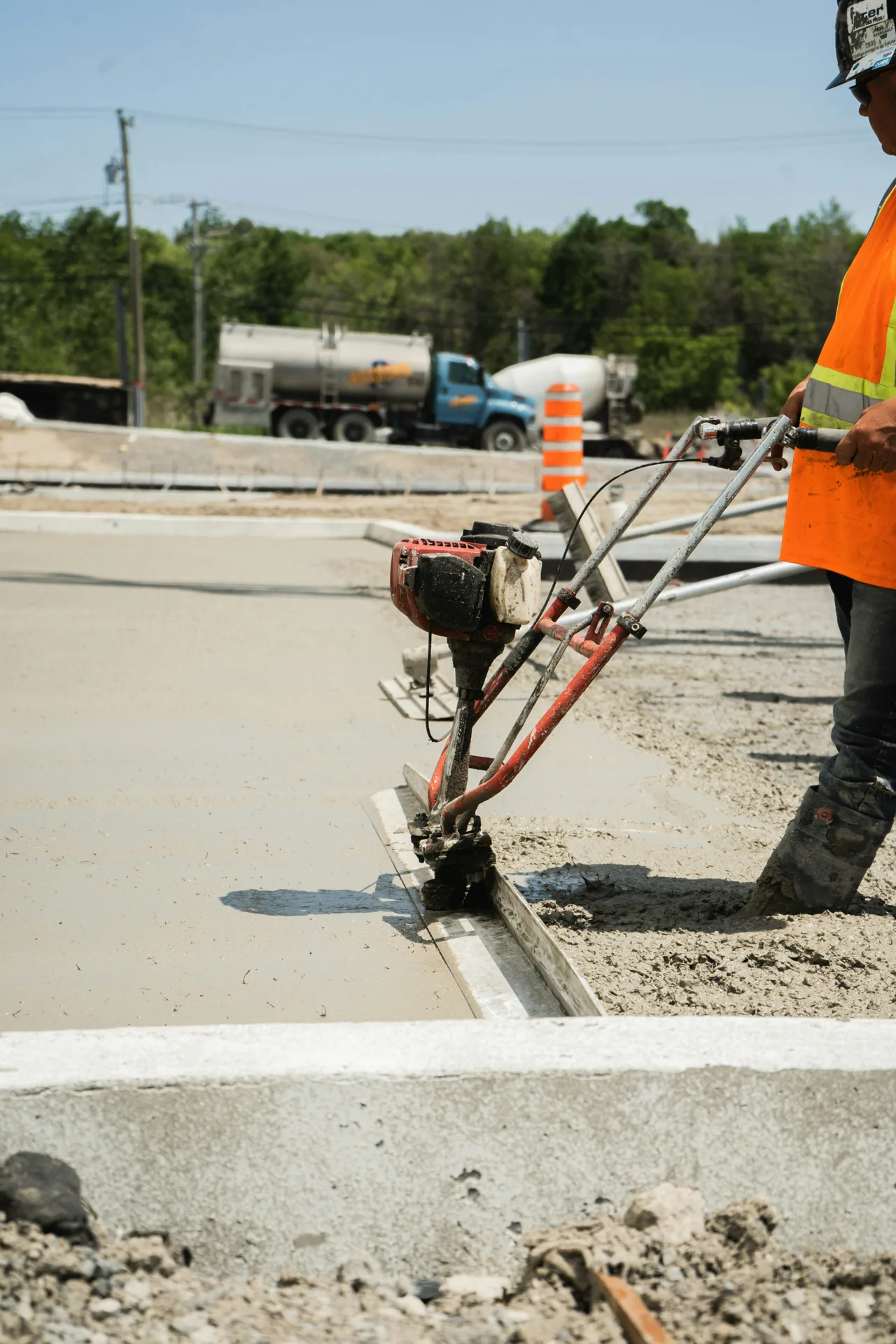 commercial curb and site concrete being power-screeded in Boston