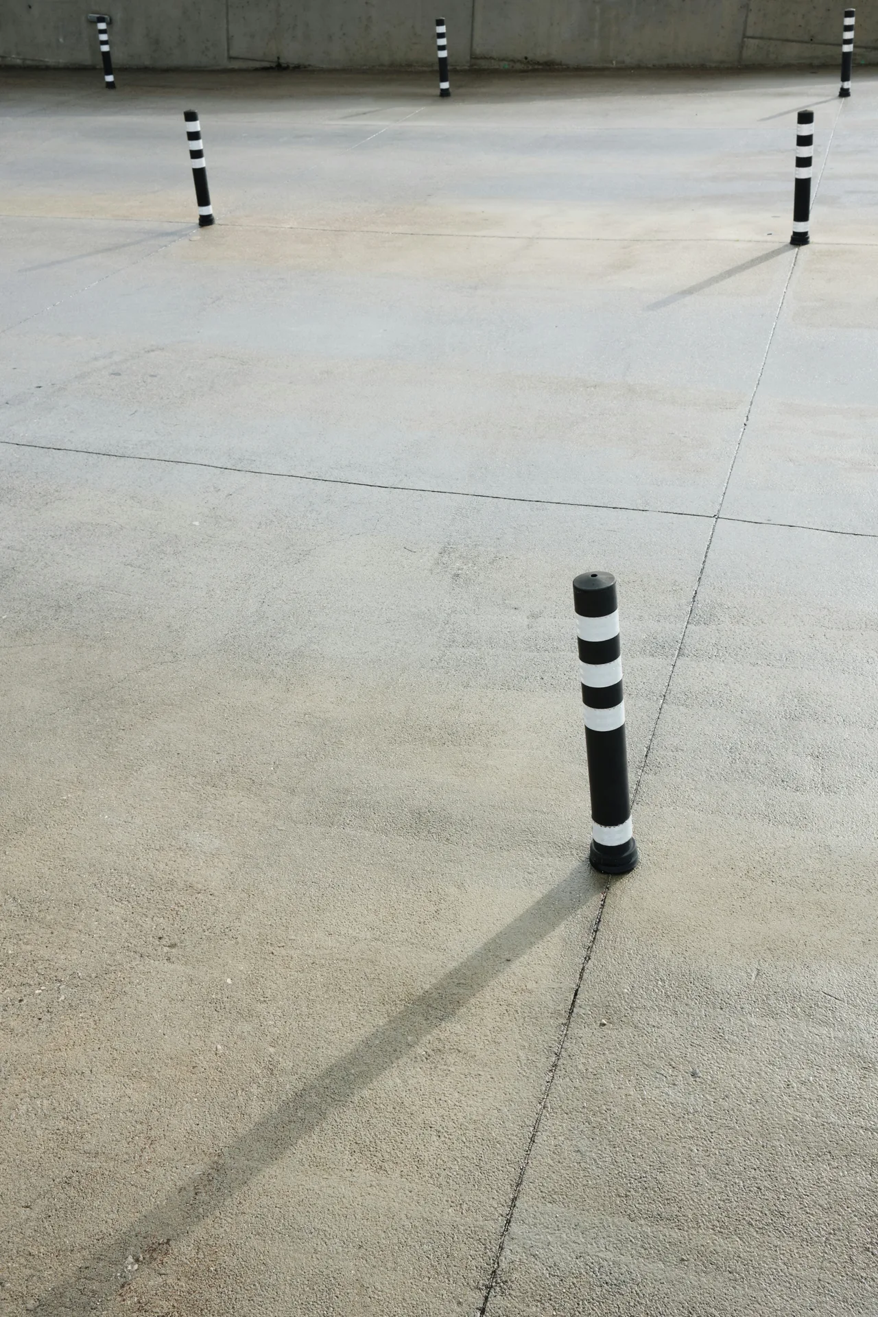 broom-finished concrete parking lot with bollards in Boston