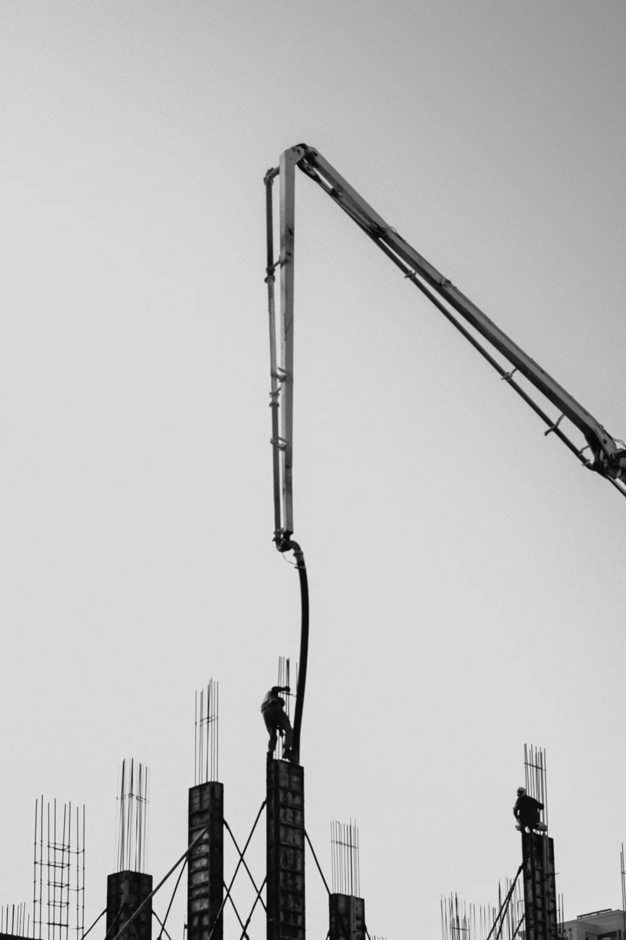 concrete pump and rebar on a tilt-up construction site in Boston