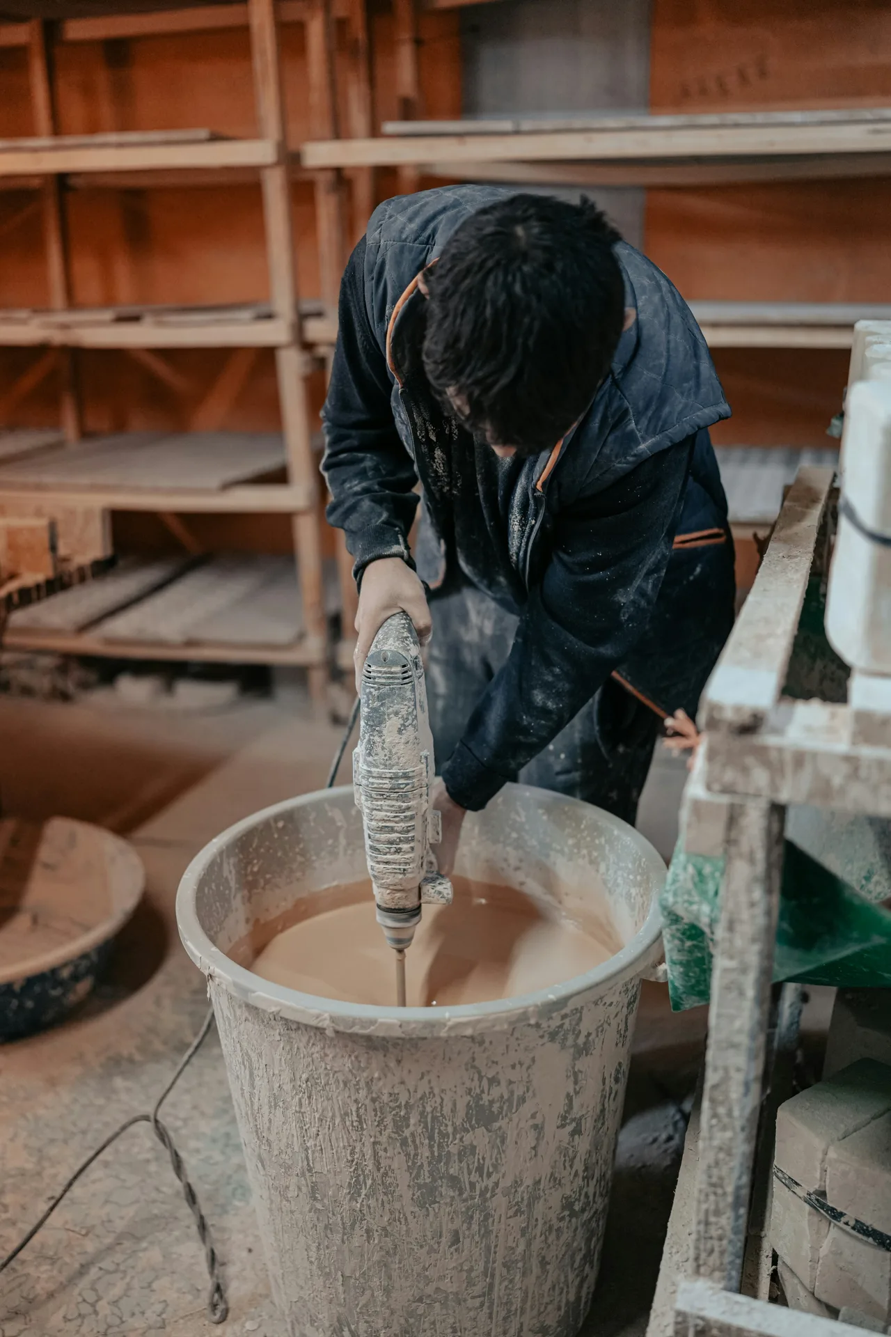 Quikrete bagged concrete being mixed in a paddle mixer on a Boston site