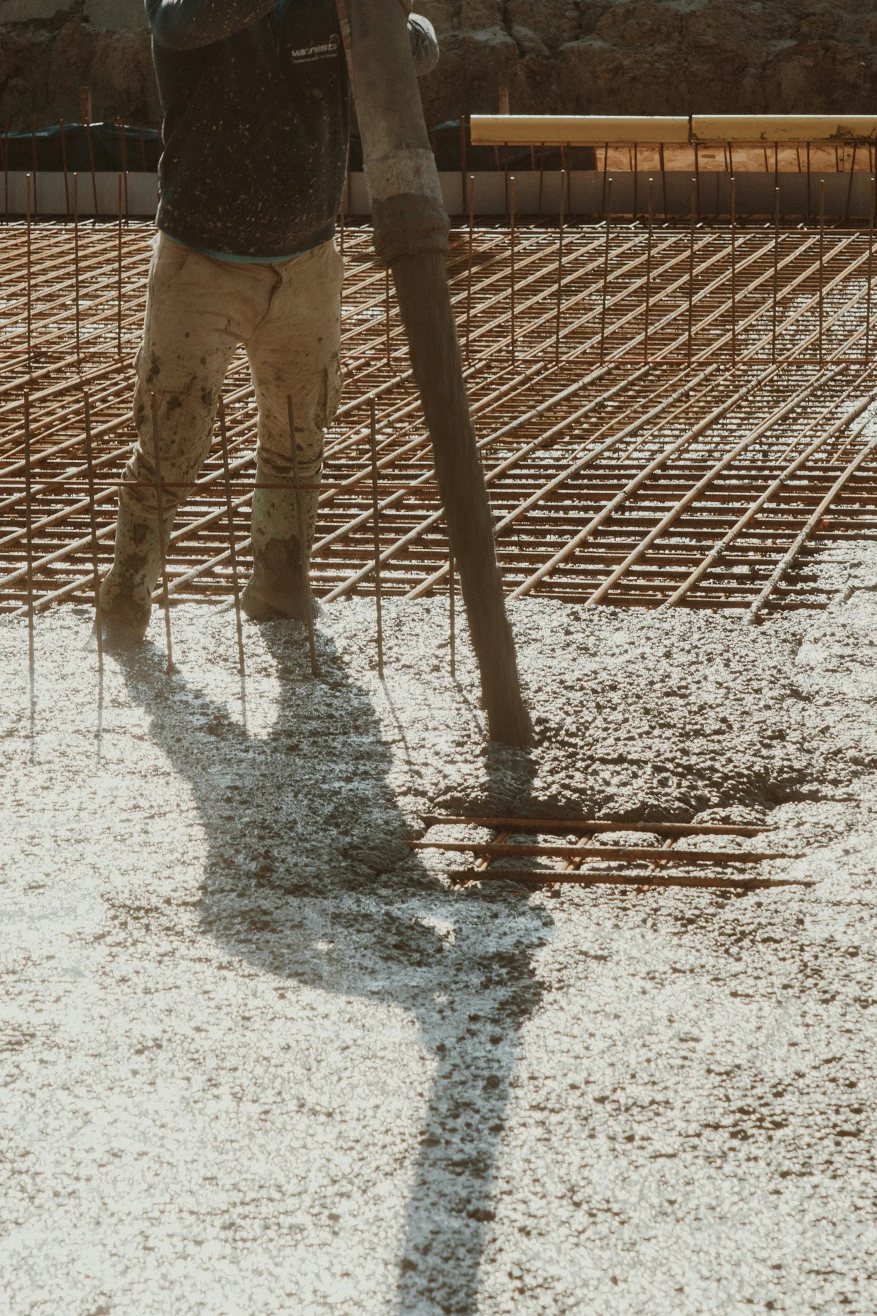 concrete pump hose placing concrete over a Boston rebar mat