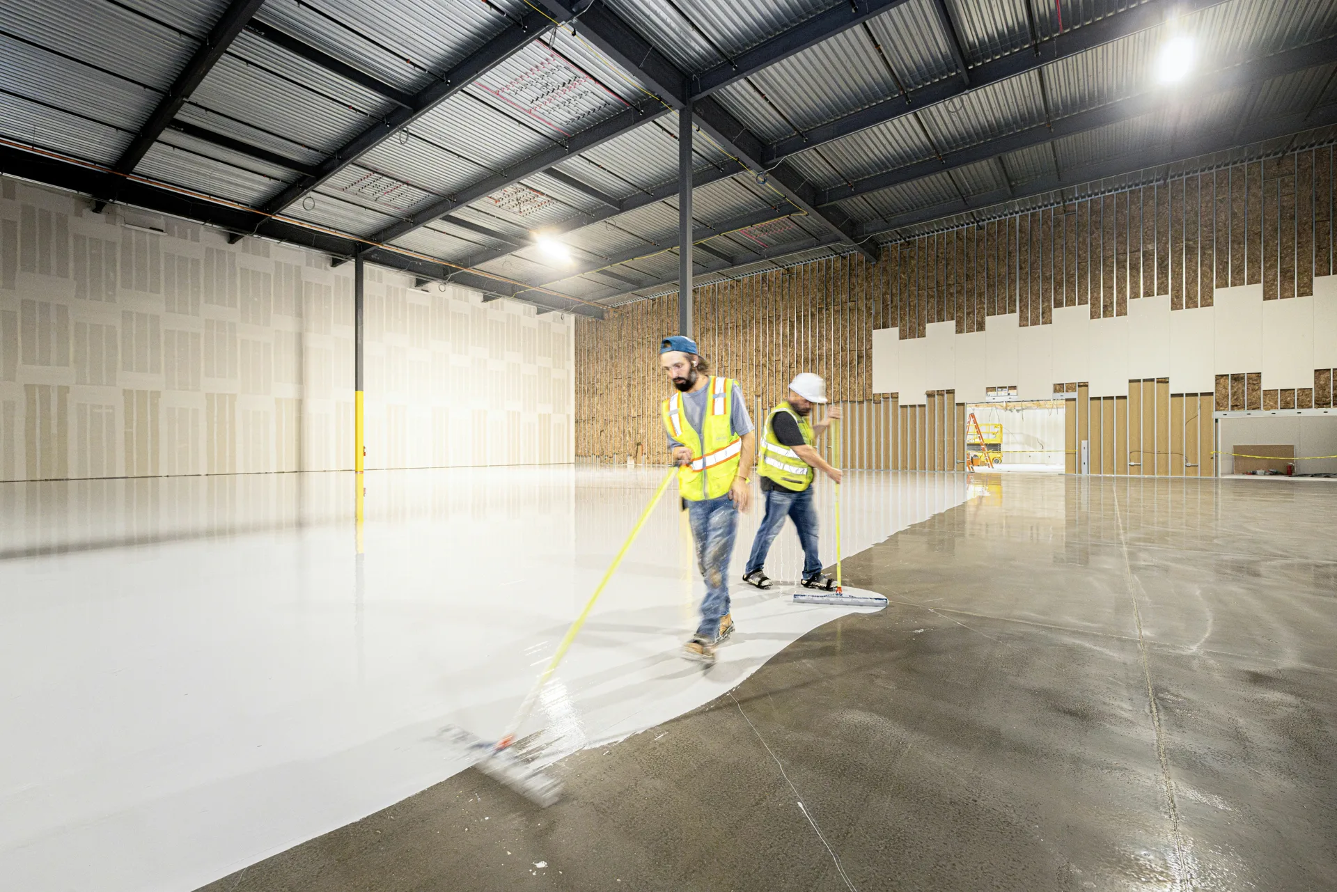 crew rolling epoxy onto a Boston garage floor