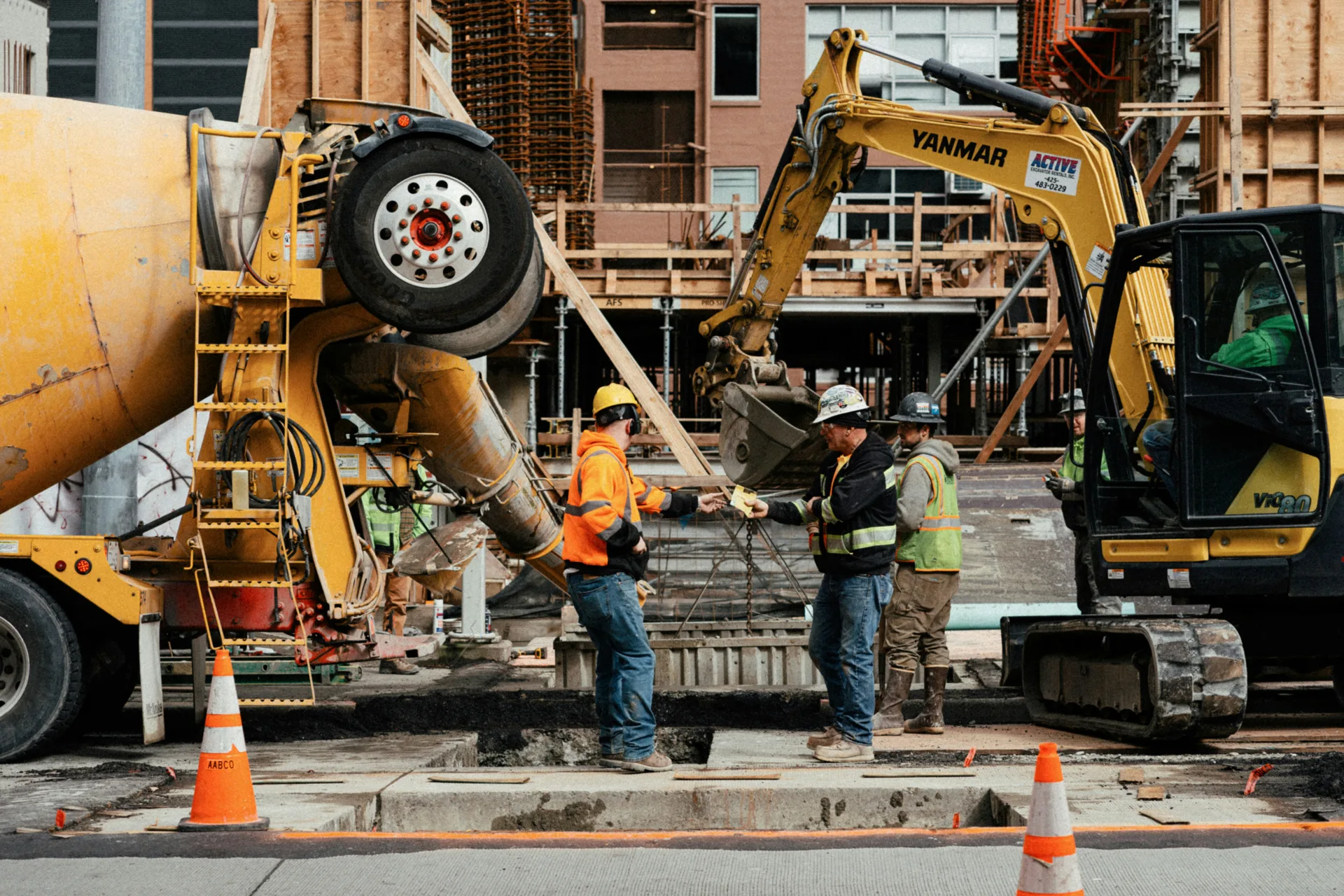 ready mix concrete pour on a Boston urban site with a mini excavator