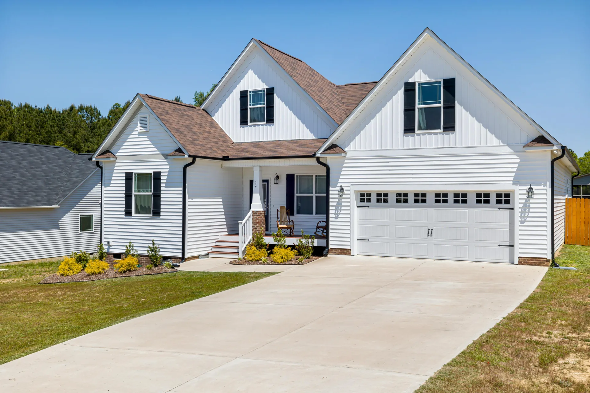long concrete driveway at a Cambridge acreage home with double garage
