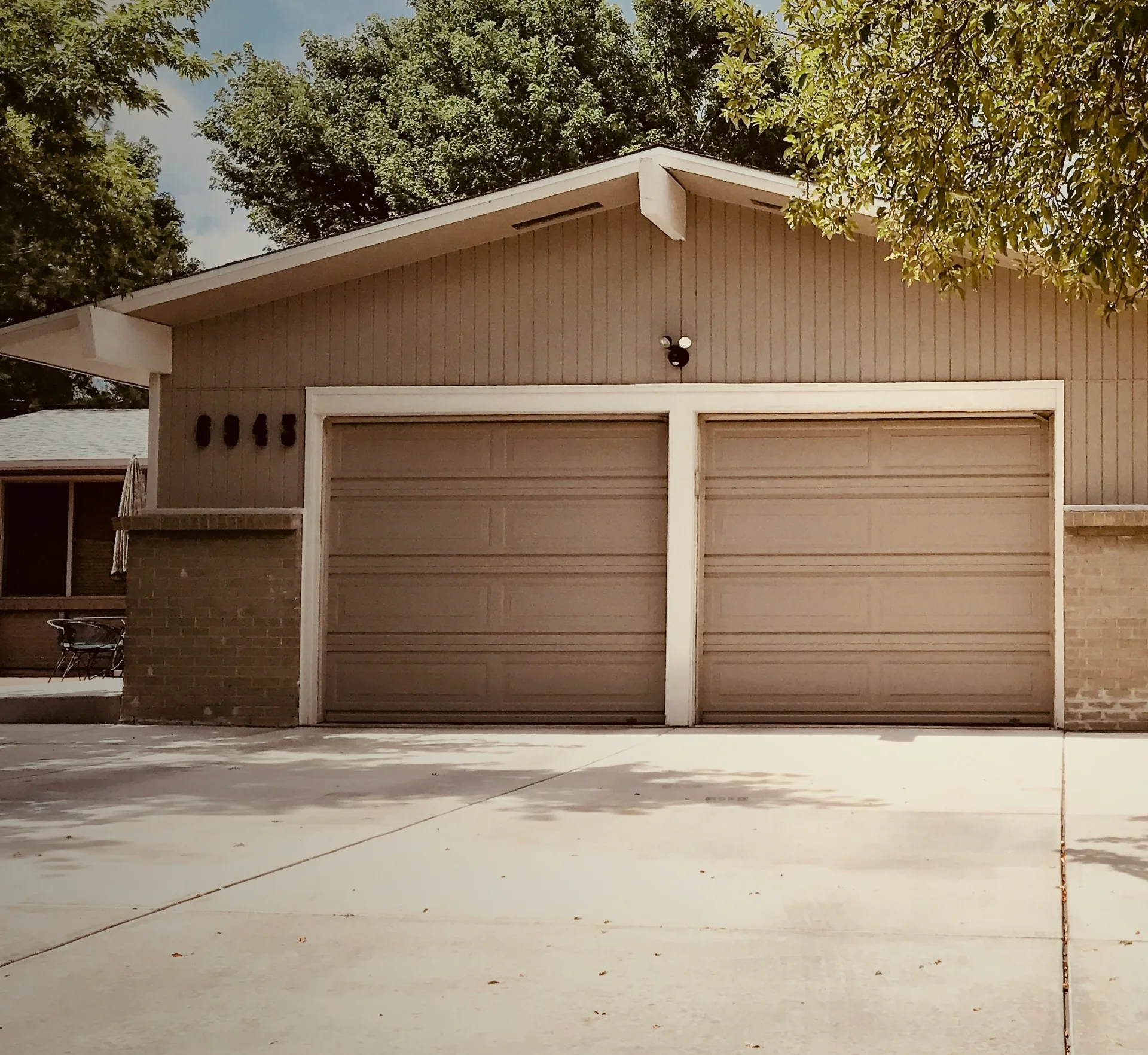 concrete driveway at a ranch home with a double garage in Boston