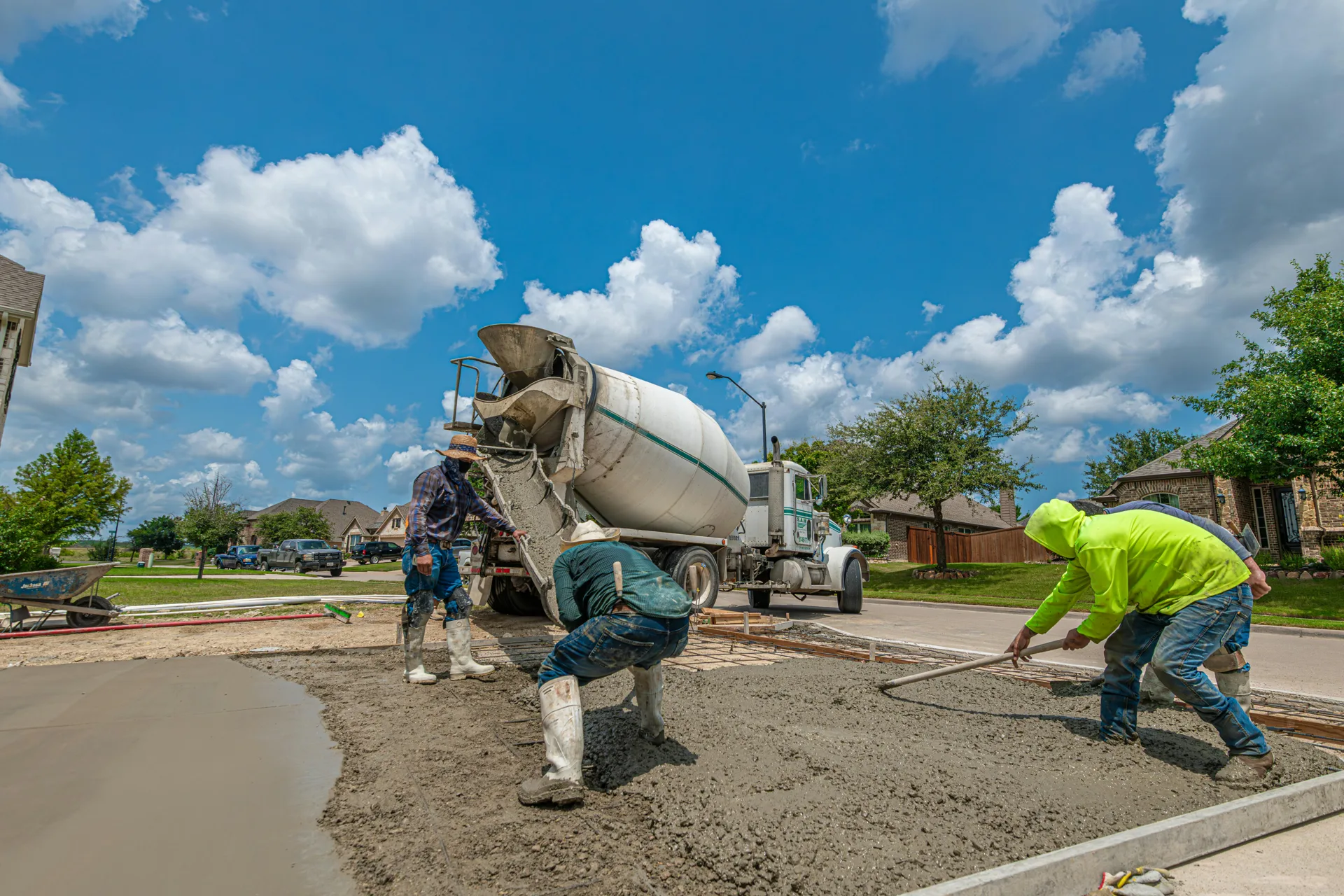 Boston concrete crew finishing a fresh driveway pour