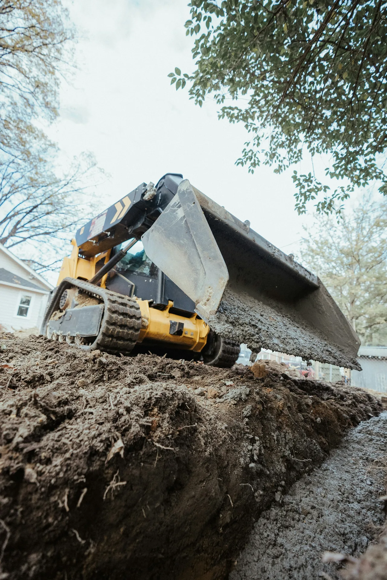 foundation repair pour with a track loader in Boston