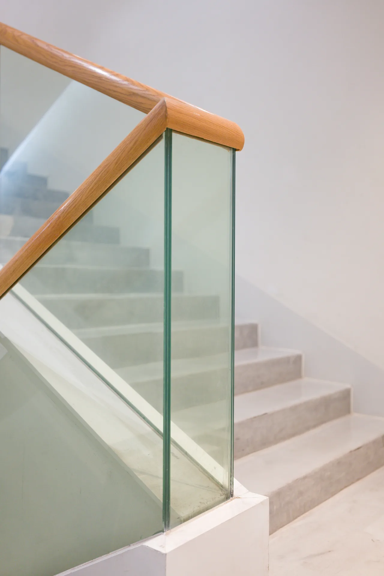 poured concrete staircase with glass railing at a Boston home