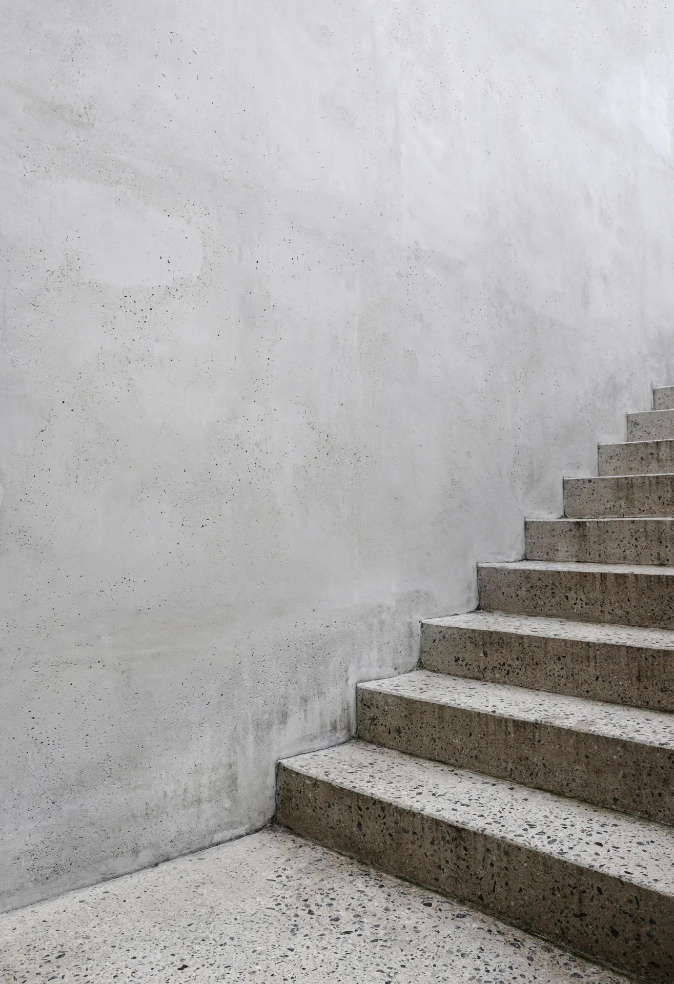 finished concrete front entry steps at a Boston home in winter