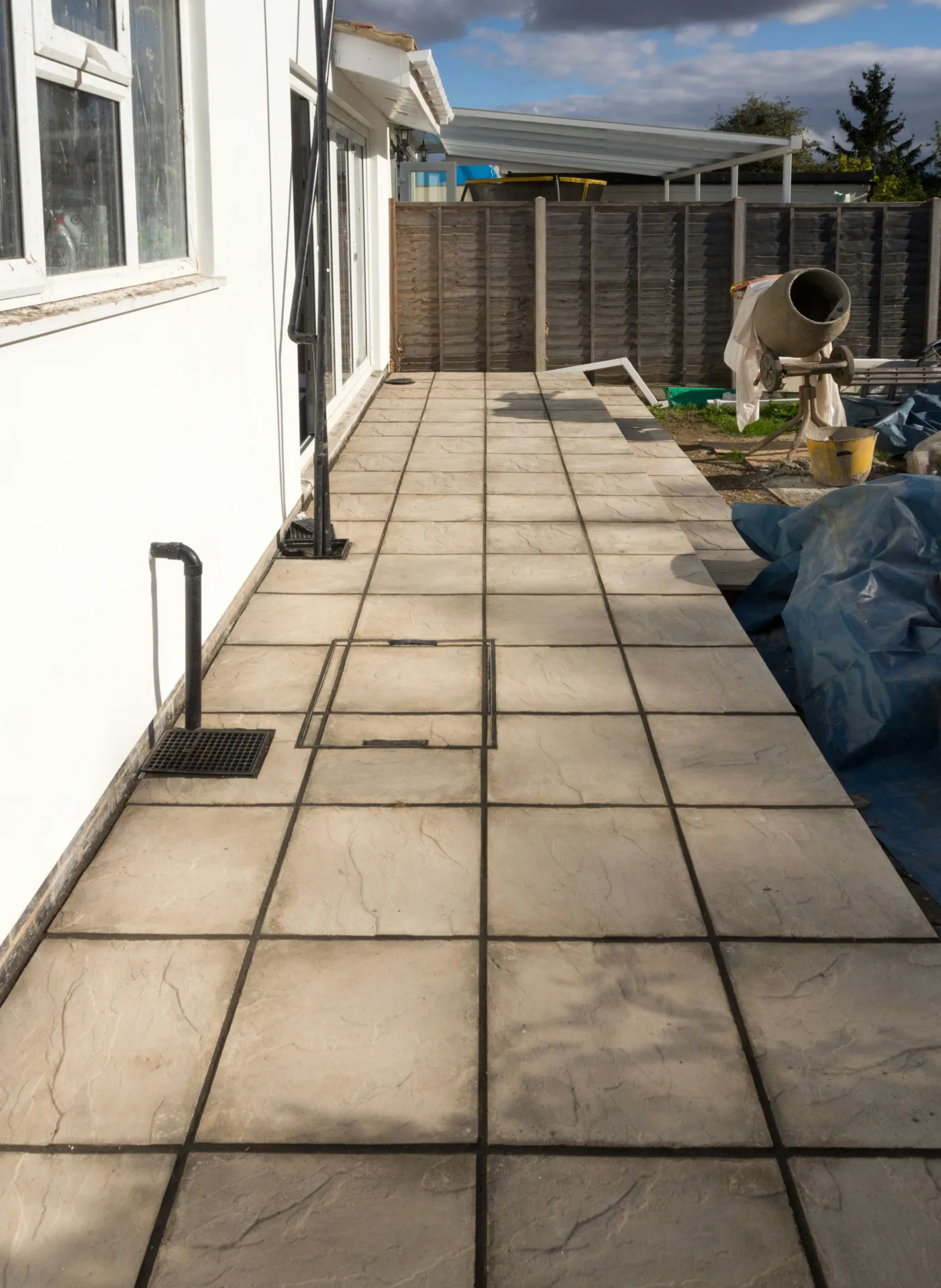 concrete walkway installation along the side yard of a Boston home